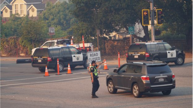 Cop directing traffic due to a road block